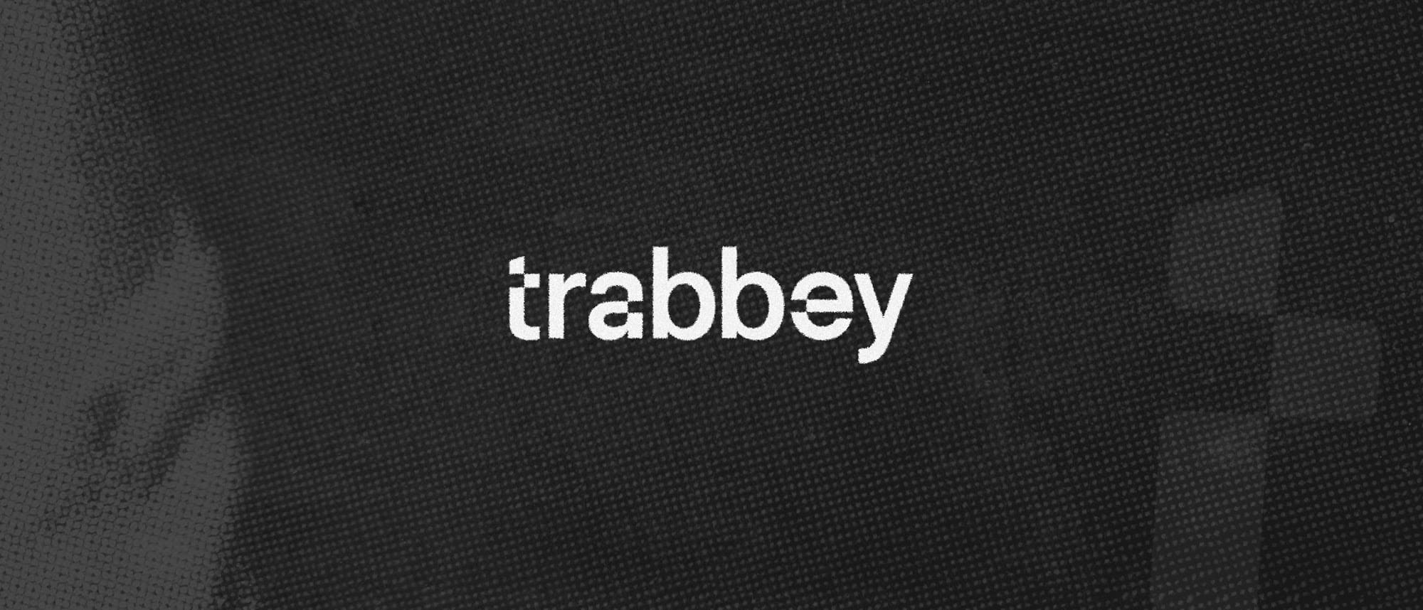 The trabbey wordmark in white on dark woven fabric